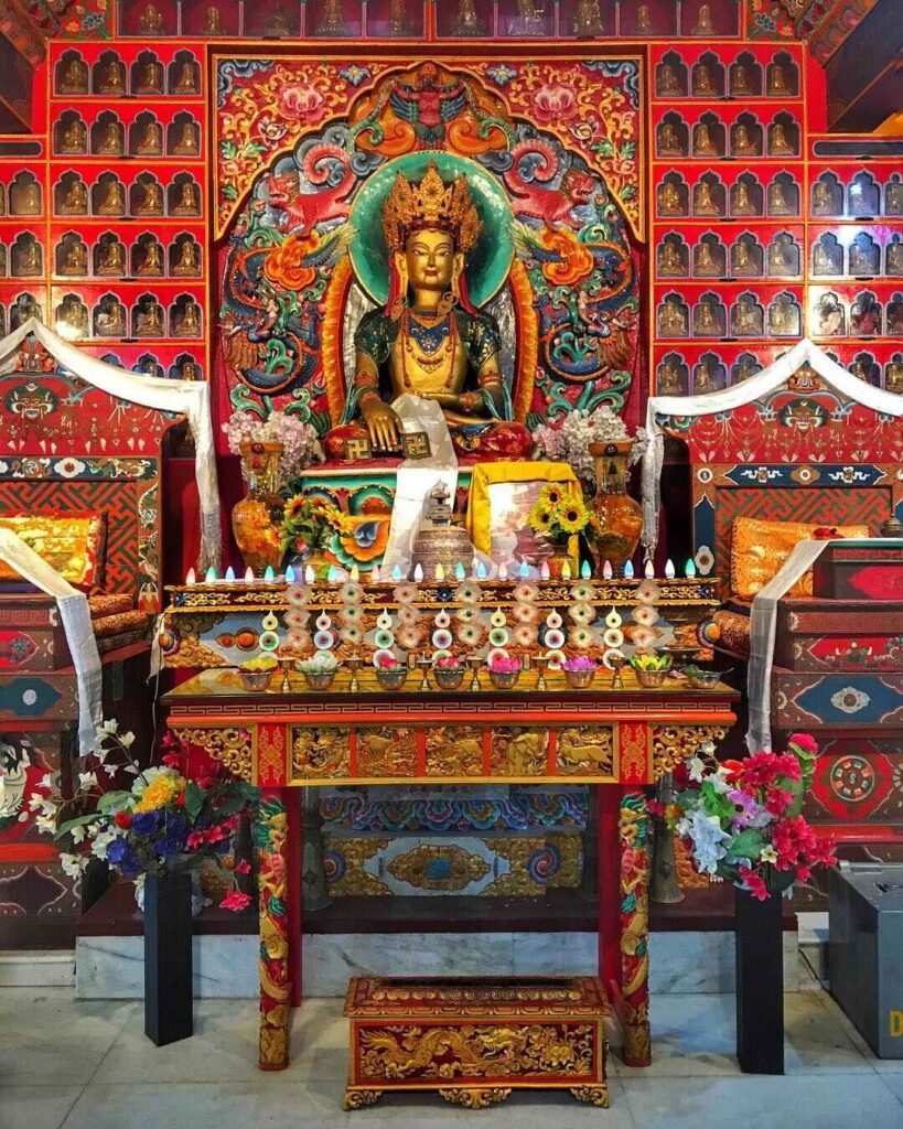 large buddha statue inside menri monastery prayer hall himachal pradesh